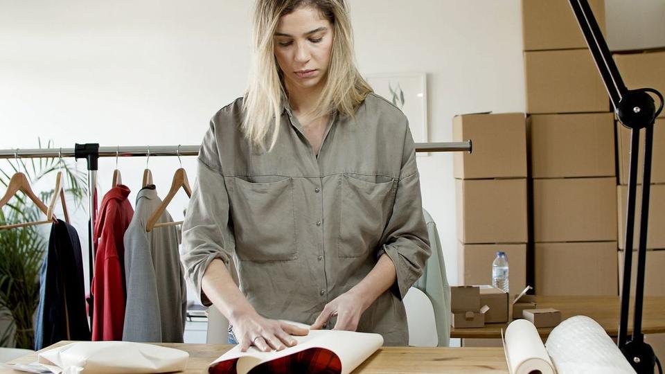 Seller wrapping an order at a packing table