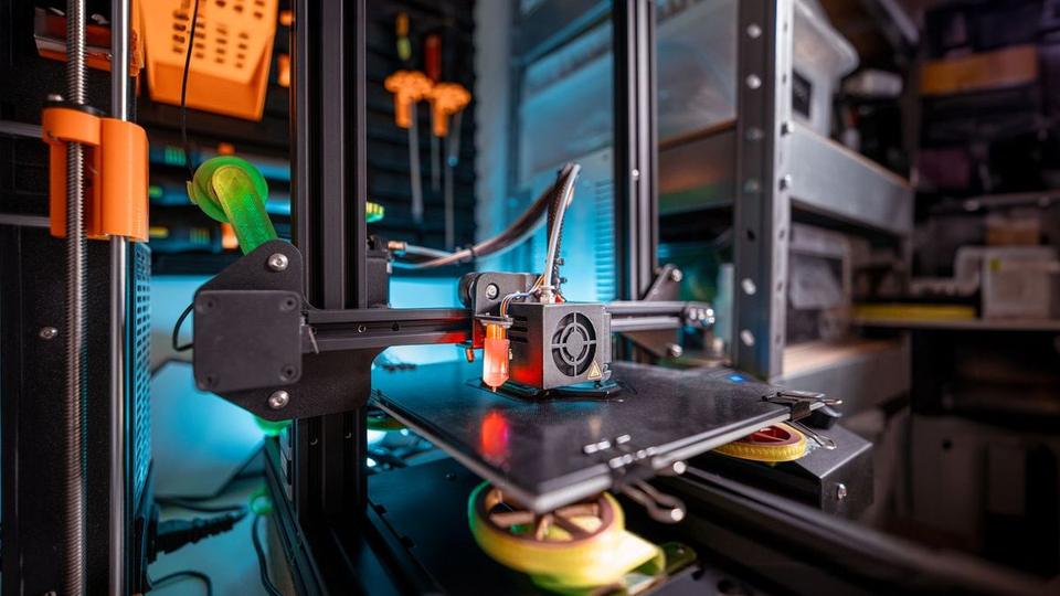 Rack of desktop 3D printers running in a home workshop